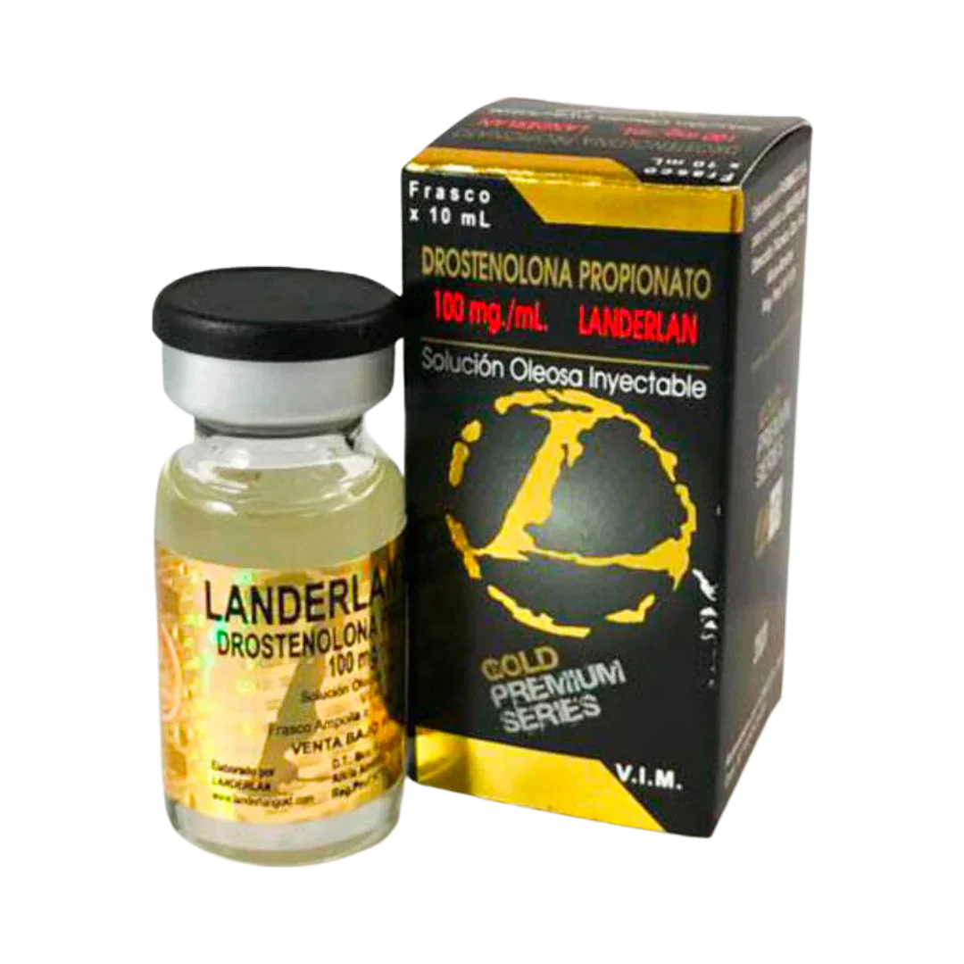 Un vial de líquido amarillo marcado Masteron - LANDERLAN 100 mg/mL se encuentra al lado de una caja negra/amarilla con un mapa del mundo y la etiqueta Gold Premium Series, que indica que es Drostenolona Propionato 100 mg/mL Landerlan Solución Oleosa Inyectable 10 mL.