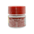 Un pequeño envase de plástico blanco con tapa roja tiene la etiqueta Turinabol - ROTTERDAM de Get Fit México. Contiene 50 tabletas de 10 mg de 4-clorodehidrometiltestosterona para uso oral. La etiqueta roja incluye un código QR y una fecha de vencimiento del 26/12/2020 para una fácil verificación.